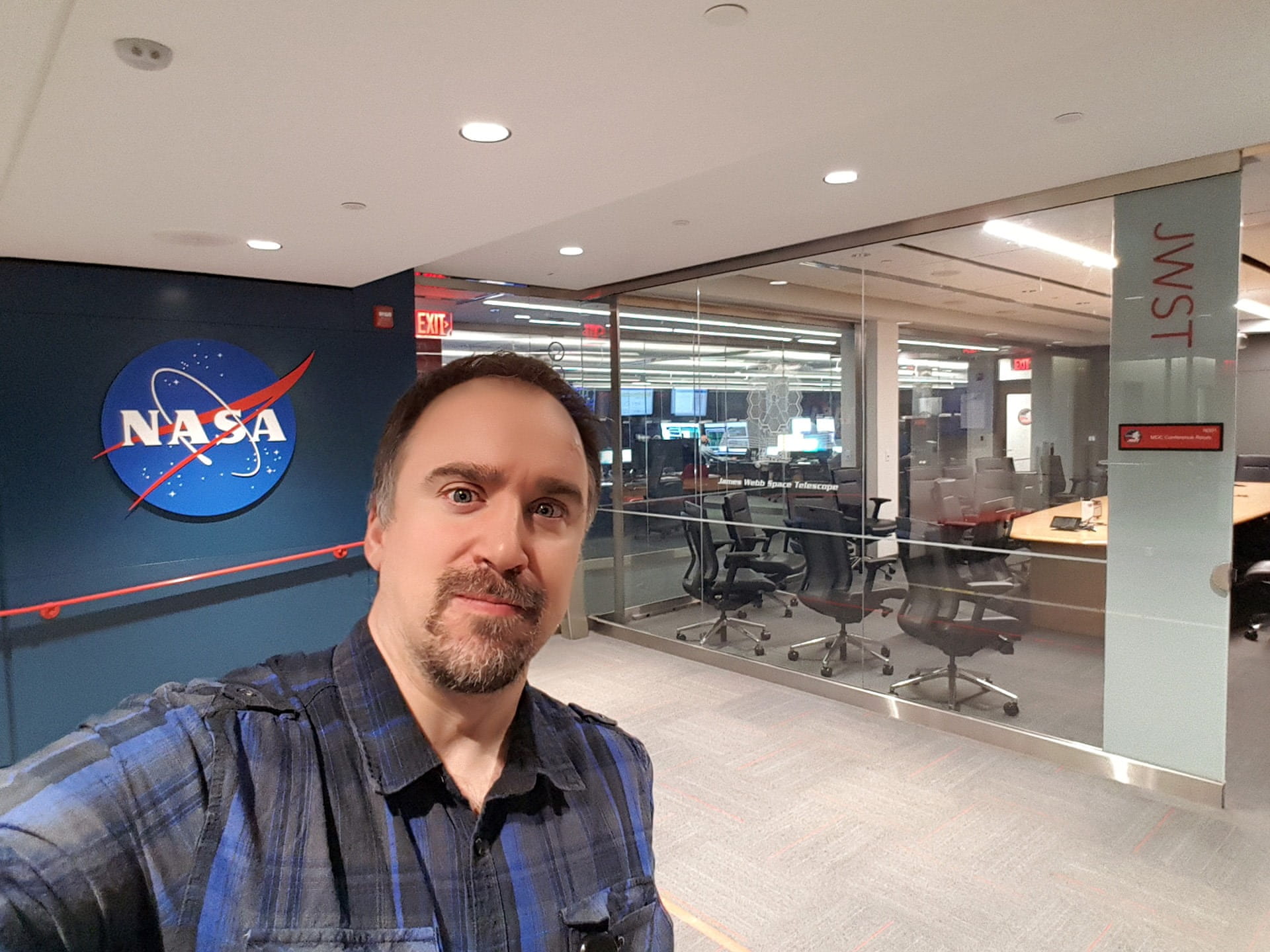 Örs Hunor Detre, organizer of the Student Spacelab Network SSN, in an office with NASA logo in background