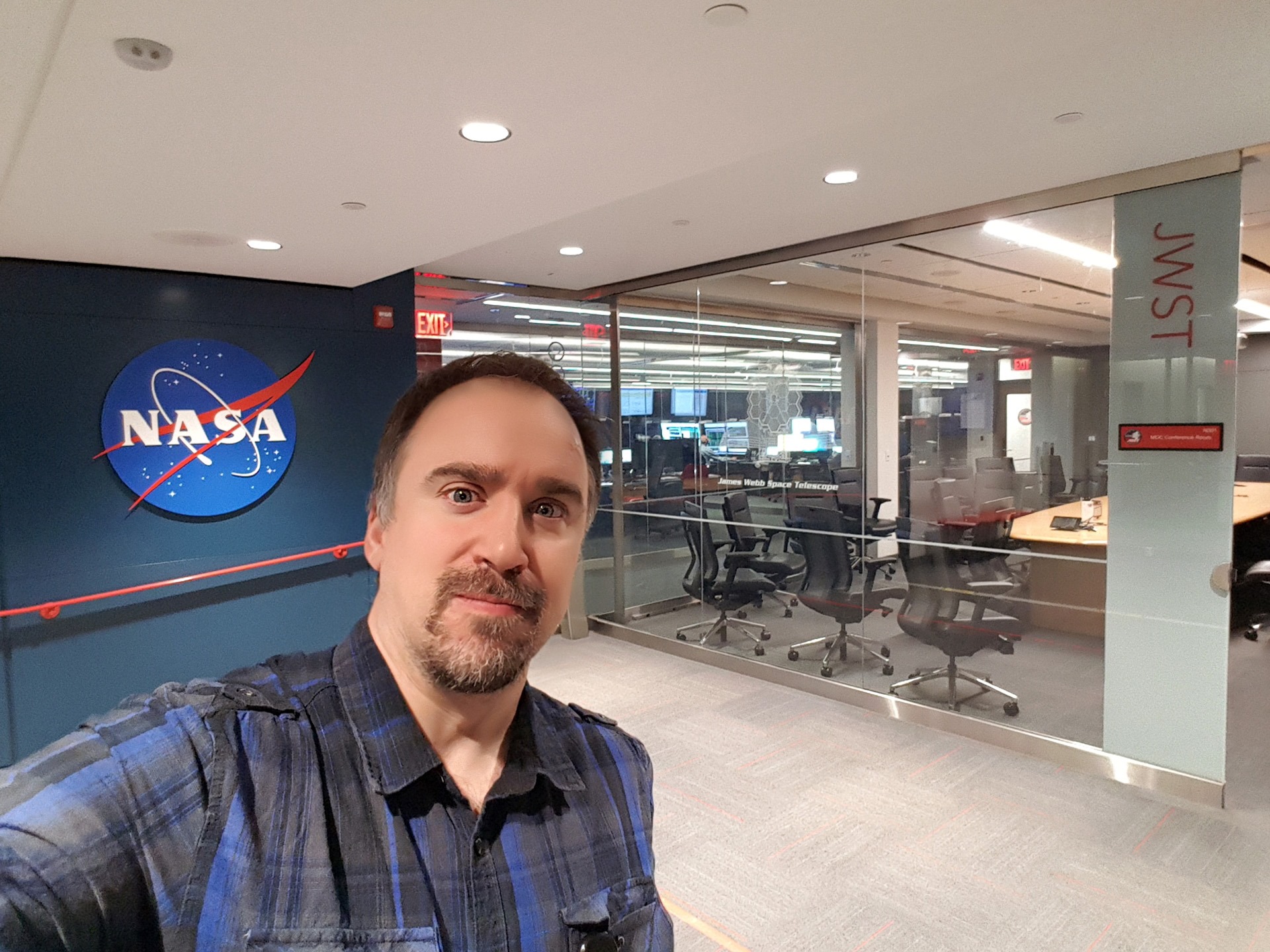 Örs Hunor Detre, organizer of the Student Spacelab Network SSN, in an office with NASA logo in background